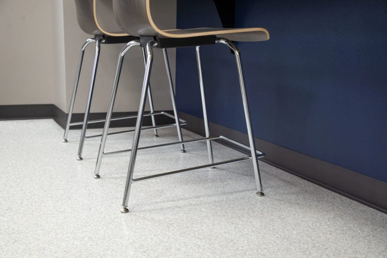there are two chairs sitting in front of a counter in a room